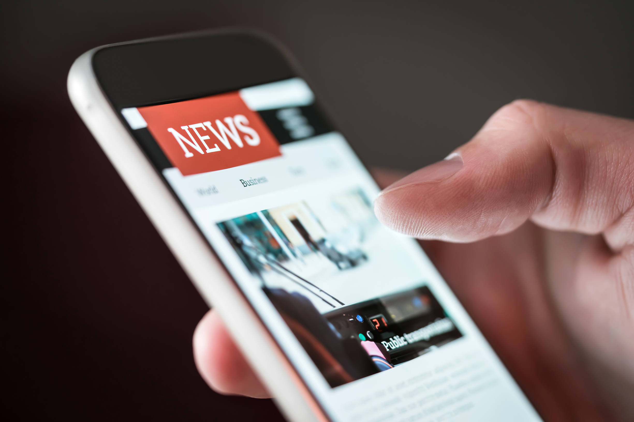 Person scrolls phone for news