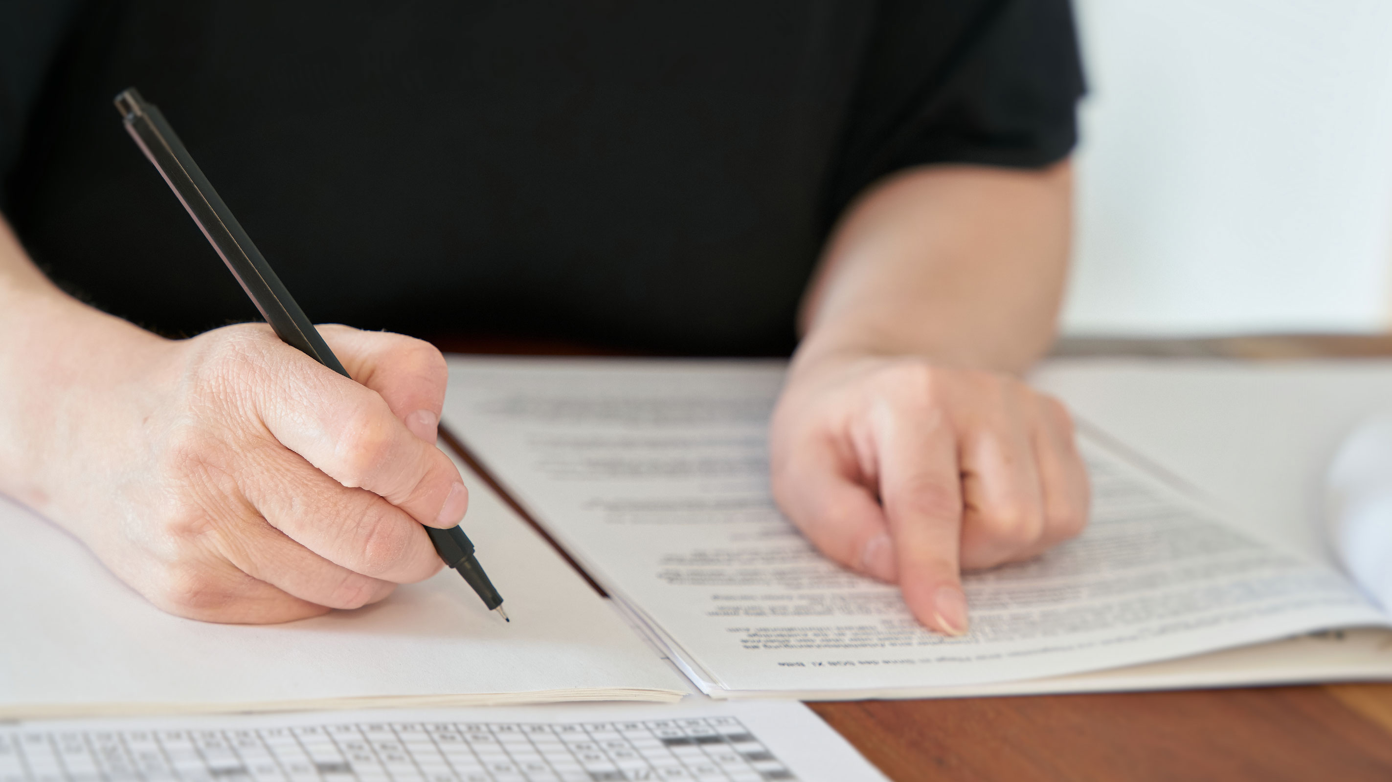 Woman holds pen with document